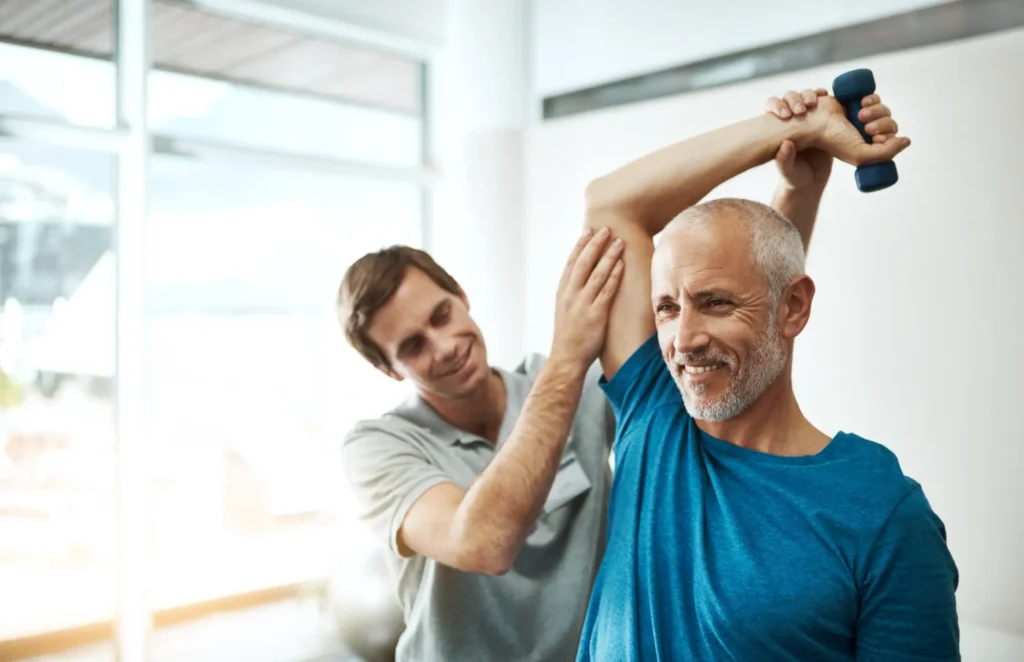 Man in physical therapy following shoulder replacement surgery and will be ready to drive soon