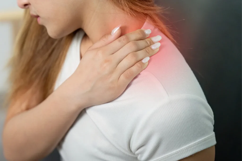 Woman holding shoulder in pain