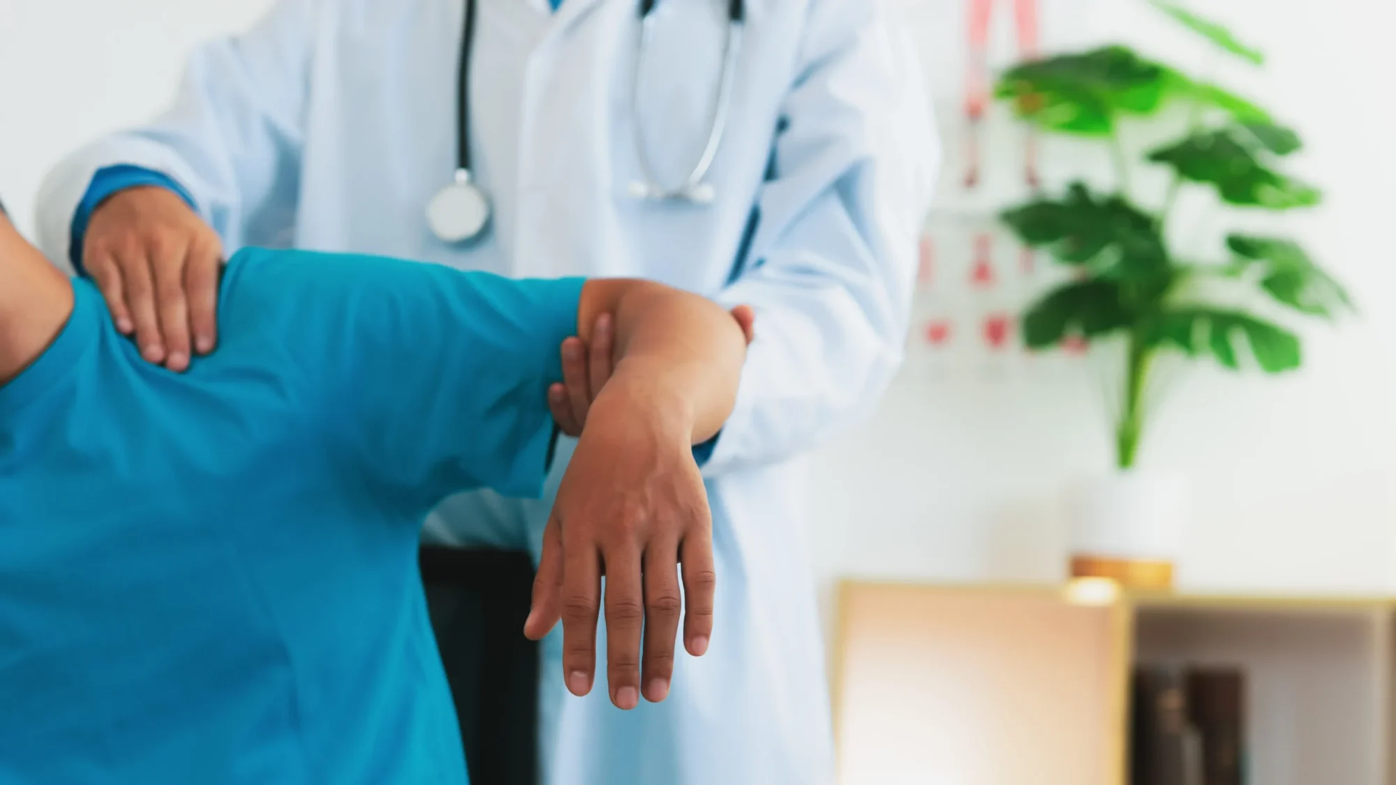 patient recovering from a shoulder arthroscopy procedure with their doctor.