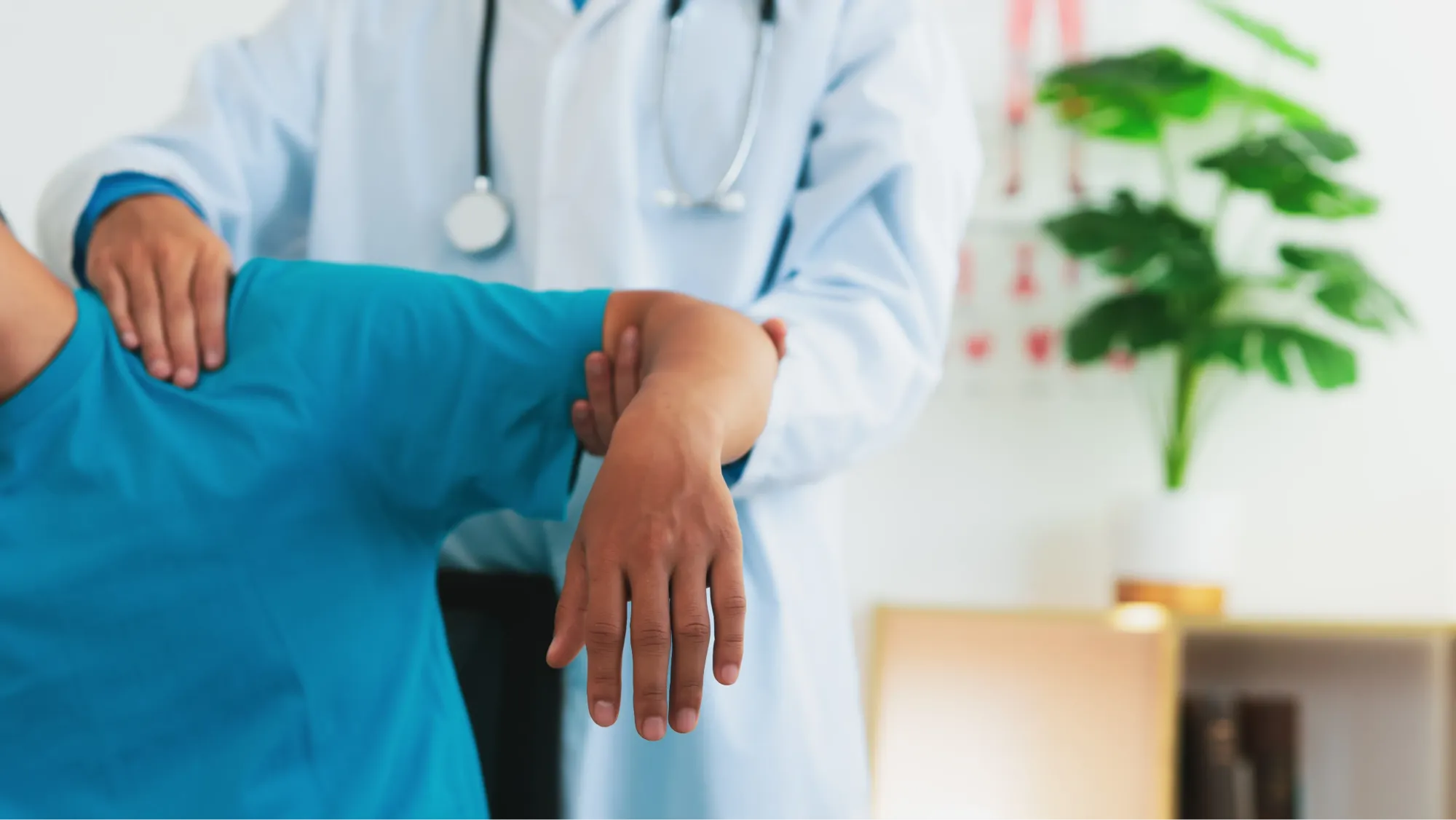 patient recovering from a shoulder arthroscopy procedure with their doctor.